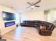 Stylish living room showcasing a sectional sofa, fireplace, and ceiling fan at 116 Jodi Pl, Locust Grove, GA 30248