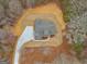 Overhead view of the home with a gray roof, newly seeded lawn, and concrete driveway on a wooded lot at 426 Ayers Rd, Bowdon, GA 30108