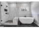 Modern bathroom featuring glass enclosed shower, soaking tub and black marble floors at 426 Ayers Rd, Bowdon, GA 30108