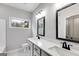 Bathroom with double vanity, black fixtures, and large mirror at 426 Ayers Rd, Bowdon, GA 30108
