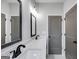 Bright bathroom with double vanity, black framed mirrors, and shower/toilet combo at 426 Ayers Rd, Bowdon, GA 30108