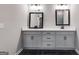 Bathroom vanity featuring white countertops, framed mirrors and black fixtures at 426 Ayers Rd, Bowdon, GA 30108