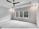 Spacious primary bedroom featuring a tray ceiling, fan, and multiple windows at 426 Ayers Rd, Bowdon, GA 30108