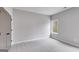 Bedroom featuring neutral carpet, a window, and a gray door at 426 Ayers Rd, Bowdon, GA 30108