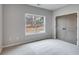 Neutral bedroom with carpet, double door closet, and view of the backyard at 426 Ayers Rd, Bowdon, GA 30108