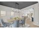 Dining room area with light wood floors, modern decor, gray walls and access to the kitchen and living area at 426 Ayers Rd, Bowdon, GA 30108