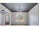 Dining room featuring light grey walls, modern light fixture, and views of the front yard at 426 Ayers Rd, Bowdon, GA 30108