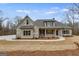 Charming single Gathering home featuring stone accents, neutral color palette, and inviting covered front porch at 426 Ayers Rd, Bowdon, GA 30108