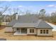 Back view of the home showing the covered patio and new construction on an oversized treed lot at 426 Ayers Rd, Bowdon, GA 30108