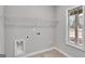 Well-lit laundry room with tile floors, window, and utility connections at 426 Ayers Rd, Bowdon, GA 30108