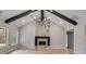 Living area with a stone fireplace, vaulted ceilings with wooden beams, and hardwood floors at 426 Ayers Rd, Bowdon, GA 30108