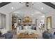 Open-concept living room with vaulted ceiling, kitchen view and modern furnishings and decor at 426 Ayers Rd, Bowdon, GA 30108