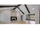 Bright living room with stone fireplace, vaulted ceilings, wooden beams and a view to a breakfast nook at 426 Ayers Rd, Bowdon, GA 30108