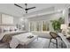 Relaxing main bedroom with tray ceiling, light-colored walls, seating and large windows with wooded views at 426 Ayers Rd, Bowdon, GA 30108