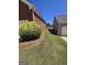Spacious backyard with manicured lawn and brick exterior at 1601 Celestial Ct, Mcdonough, GA 30253
