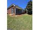 Backyard with lush grass, pine straw landscaping, and screened in porch at 1601 Celestial Ct, Mcdonough, GA 30253