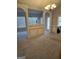 Spacious dining room with chandelier, neutral carpet, and arched entryways to the living room and hallway at 1601 Celestial Ct, Mcdonough, GA 30253