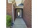 Inviting covered front entrance featuring brick exterior and a glass front door at 1601 Celestial Ct, Mcdonough, GA 30253