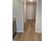 Hallway with wood flooring and an access to closets and rooms with gray paint at 1601 Celestial Ct, Mcdonough, GA 30253