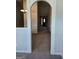 Hallway with neutral carpet, arched doorways, and decorative wall paneling providing an inviting passageway at 1601 Celestial Ct, Mcdonough, GA 30253