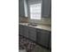 Kitchen featuring gray cabinets, stainless steel appliances, and a double sink at 1601 Celestial Ct, Mcdonough, GA 30253