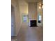 Bright living room with fireplace, ceiling fan, neutral carpet, and a view to another room through arched openings at 1601 Celestial Ct, Mcdonough, GA 30253