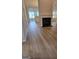 Open-concept living room featuring a fireplace, hardwood floors, and dining room view at 1601 Celestial Ct, Mcdonough, GA 30253
