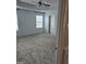 Spacious primary bedroom featuring tray ceiling, neutral carpet, and plenty of natural light at 1601 Celestial Ct, Mcdonough, GA 30253