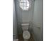 Bathroom toilet with support bars and an ornate window at 1601 Celestial Ct, Mcdonough, GA 30253