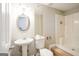 Cozy bathroom with a pedestal sink, toilet, and shower with tile surround at 849 Wagon Wheel Cir, Fayetteville, GA 30214