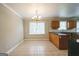 Dining area features classic chandelier and tile floor, adjacent to kitchen with light colored walls at 849 Wagon Wheel Cir, Fayetteville, GA 30214