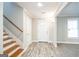 Bright foyer featuring updated floors, staircase, and entry door with natural light at 849 Wagon Wheel Cir, Fayetteville, GA 30214