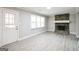 Bright living room with stone fireplace, modern flooring, and large window, providing ample natural light at 849 Wagon Wheel Cir, Fayetteville, GA 30214