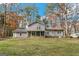 Back of home featuring screened-in porch, traditional siding and lush green lawn at 849 Wagon Wheel Cir, Fayetteville, GA 30214
