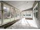 Enclosed sunroom featuring brick base and multiple windows offering a scenic view of the backyard at 849 Wagon Wheel Cir, Fayetteville, GA 30214