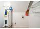 Small utility room featuring a water heater, wall fixtures and tile flooring at 849 Wagon Wheel Cir, Fayetteville, GA 30214