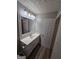 Bathroom with a large mirror, vanity, and neutral color scheme at 475 Lakeside Cir, Covington, GA 30016