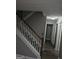 Hallway with staircase and hardwood flooring, providing access to other rooms at 475 Lakeside Cir, Covington, GA 30016