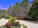 Landscaped front yard featuring decorative bushes and a circular driveway entrance at 1064 Highway 20 E, Mcdonough, GA 30252