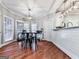 Bright kitchen nook features hardwood floors, a modern light fixture, and a breakfast bar with seating at 1009 Fairway Seven, Villa Rica, GA 30180