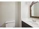 Cozy half-bath features a white countertop with a wicker mirror accent at 3863 Meeting St, Duluth, GA 30096