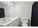 Simple bathroom featuring white cabinets, a white sink, and a toilet at 3863 Meeting St, Duluth, GA 30096