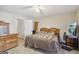 Bedroom features tile flooring, white ceiling fan, and closet at 3863 Meeting St, Duluth, GA 30096