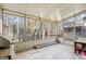 Enclosed sunroom with tile flooring, floor-to-ceiling windows overlooking the wooded backyard at 3863 Meeting St, Duluth, GA 30096