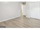 A bedroom with white walls, wood flooring, and a closet with bi-fold doors at 2825 Battlecrest Dr, Decatur, GA 30034
