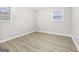 Bedroom with wood flooring, two windows, and light gray walls at 2825 Battlecrest Dr, Decatur, GA 30034