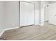 Bedroom showcasing a closet with folding doors, wood flooring, and neutral decor at 2825 Battlecrest Dr, Decatur, GA 30034