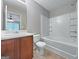 Neutral bathroom features a white shower-tub combo and a wood vanity with a light countertop at 5828 Union Walk Dr, Union City, GA 30291