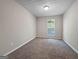 Neutral bedroom has plush carpet, a window, and a textured ceiling for comfort and style at 5828 Union Walk Dr, Union City, GA 30291