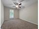 Cozy bedroom showcasing neutral walls, plush carpet, and a window for natural light at 5828 Union Walk Dr, Union City, GA 30291